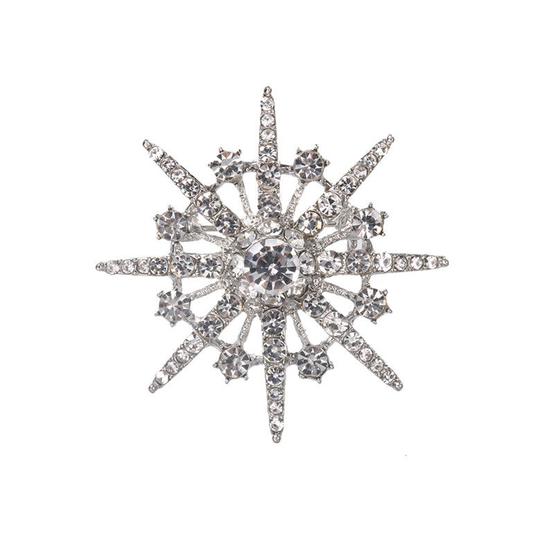 Brosch med diamant och åttauddig stjärnbrosch