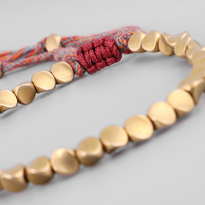 Handgjorda tibetanska buddhistiska armband på handen flätade kopparpärlor lyckorep armband och armband för kvinnor och män