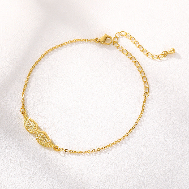 Armband med änglavingar i guld och guld
