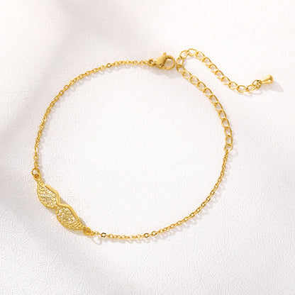 Armband med änglavingar i guld och guld