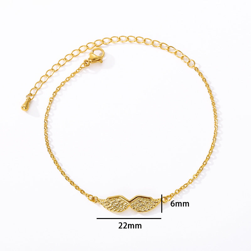 Armband med änglavingar i guld och guld