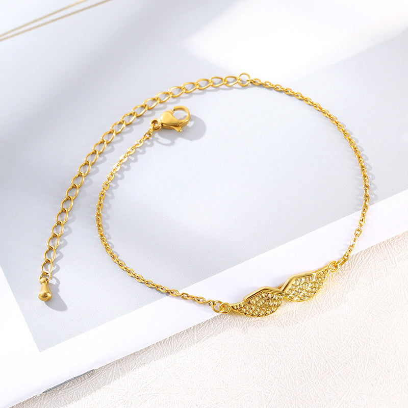 Armband med änglavingar i guld och guld
