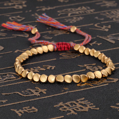 Handgjorda tibetanska buddhistiska armband på handen flätade kopparpärlor lyckorep armband och armband för kvinnor och män